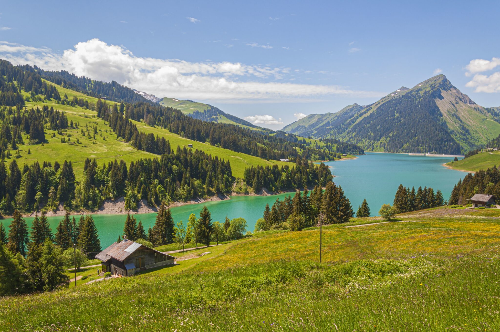 A beautiful view of a lake surrounded by mountains in Longrin lake and dam Switzerland, Swissalps
